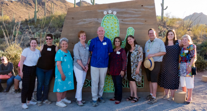 Dean Johnson and College of Education Staff in front of the Kindness Wall at Camp Cooper
