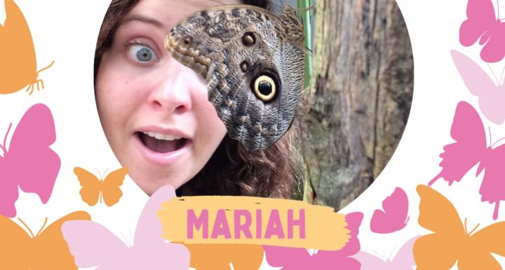 A photo of our staff member Mariah with butterflies all around.