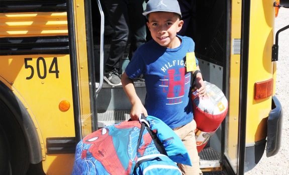 student getting off a school bus